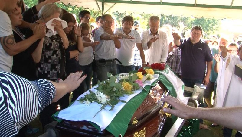 Familiares e amigos fazem uma ora&ccedil;&atilde;o ao redor do caix&atilde;o de Henzel no cemit&eacute;rio – Reprodu&ccedil;&atilde;o RICTV/Record