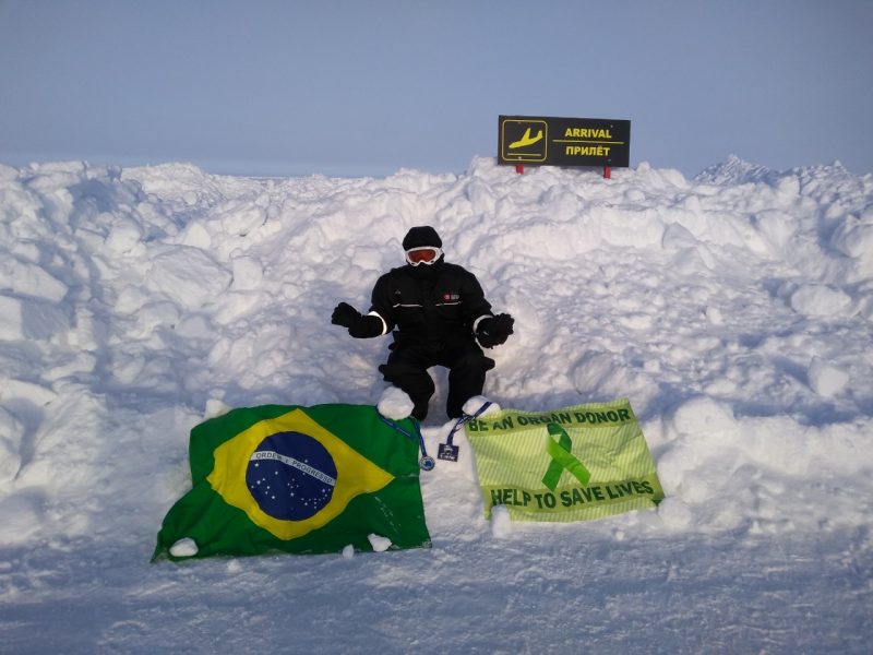 Djalma Santos com duas bandeiras que ele carrega consigo nos mais variados terrenos &#8211; Divulgação/ND