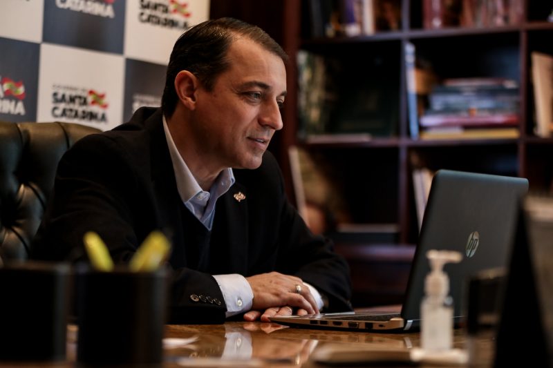 Governador Carlos Moisés olha para tela de notebook