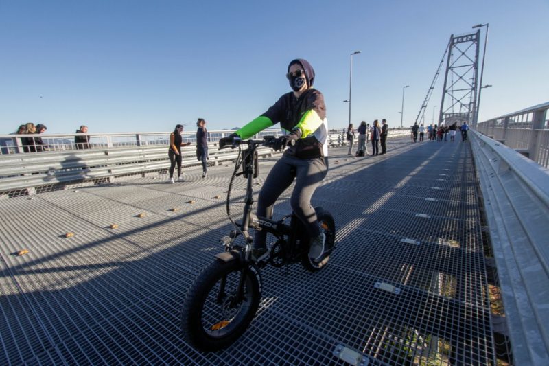 A policial Flávia Souza mora no Continente e sempre passeia com a bike elétrica na Ponte Hercílio Luz – Foto: Leo Munhoz/ND