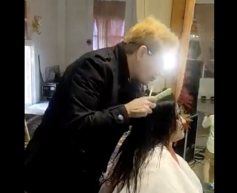 Cabeleireiro no momento do cuspe na cabe&ccedil;a da volunt&aacute;ria – Foto: Reprodu&ccedil;&atilde;o