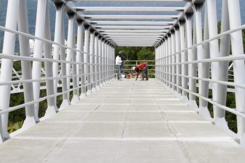 Homens fazendo novos reparos na passarela do CIC