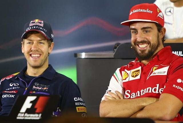 Alonso e Vettel na &eacute;poca de Ferrari e Red Bull, respectivamente. – Foto: F1