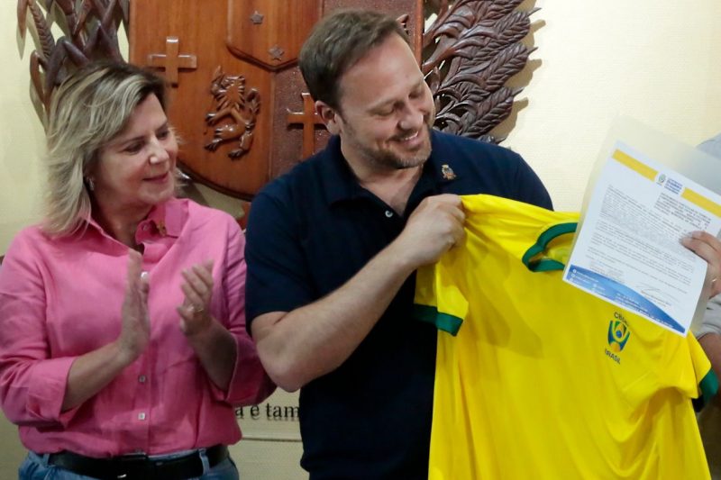 Prefeito Adriano Silva foi presenteado com uma camisa verde e amarela da Confedera&ccedil;&atilde;o Brasileira de Desporto Universit&aacute;rio – Foto: Prefeitura de Joinville