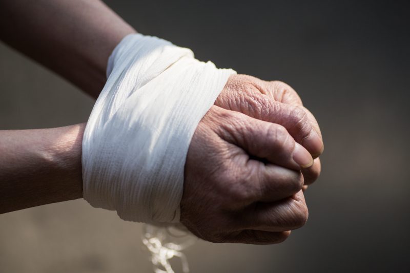 Illustrative image of a man with his hands tied