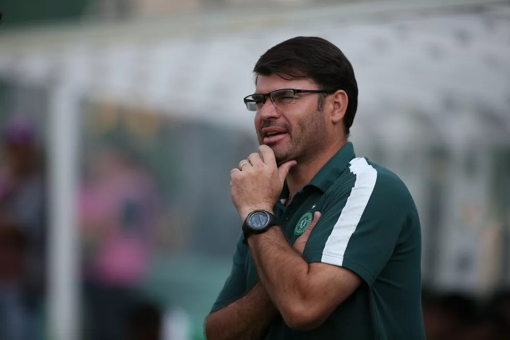 foto mostra treinador interino da chapecoense com a mão no queijo assistindo o treindo dos atletas 