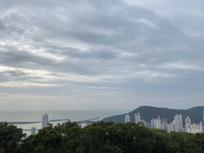 Foto do tempo em Itajaí, visto do morro da Cruz, mostrando céu nublado e o mar ao fundo