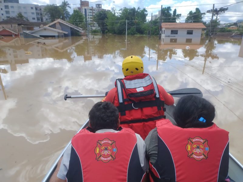 Bombeiro resgatando moradores nas enchentes de 2023