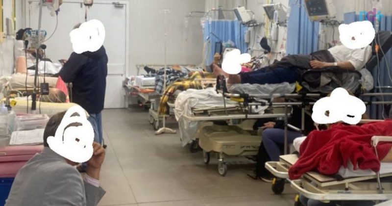 The photo shows a crowded Marieta hospital ward, with patients huddled together. 