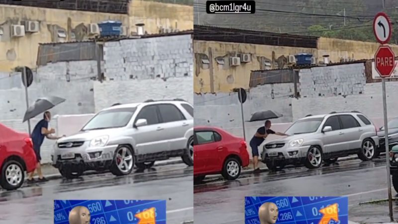 Homem lava carro com água da chuva no Centro de Balneário Camboriú