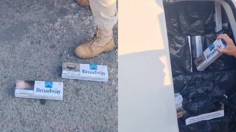 Cigarettes thrown on the floor at the feet of a policeman;  sloop with dozens of boxes of cigarettes
