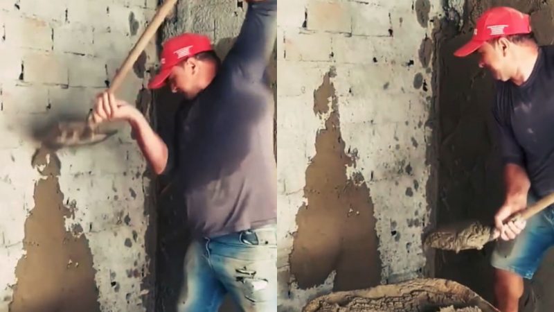 Pedreiro rebocando parede com pá