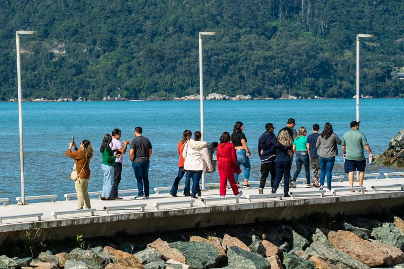 Imagem mostra turistas no molhe de Balneário Camboriú