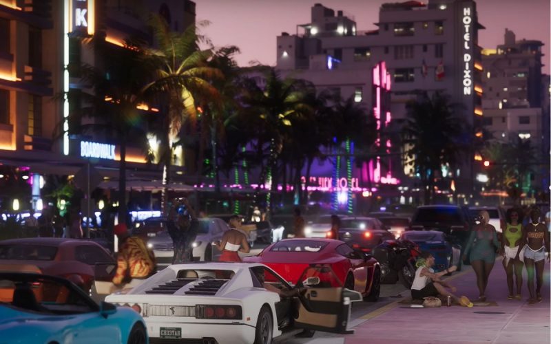 A still from the official GTA VI trailer released by Rockstar Games, showing luxury cars parked on an avenue at night.