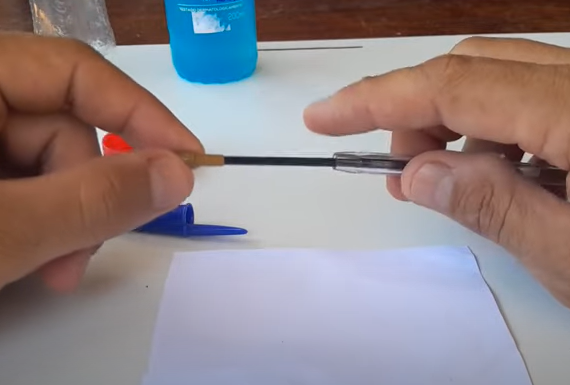 Caneta vira pistola de pintura na mão de pedreiro