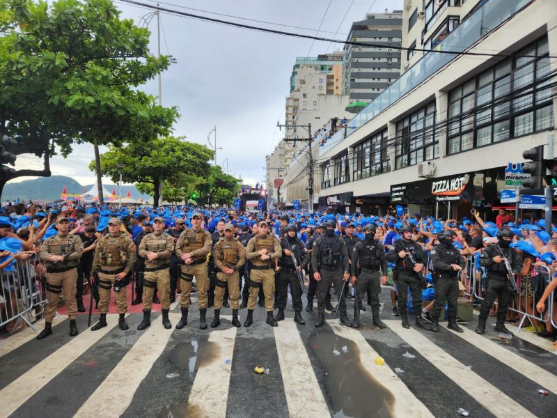 Foto da PM fazendo policiamento na Av. Atlântica de BC, com população ao fundo, ilustra prisão de mãe e filho, suspeitos de roubarem celulares