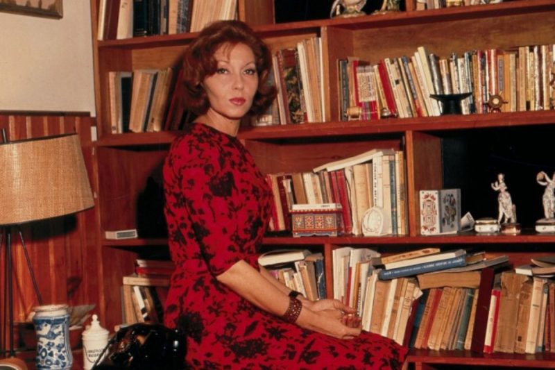 A escritora Clarice Lispector em sua biblioteca