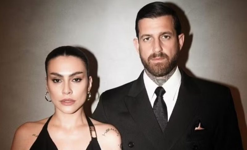 na foto, cleo pires aparece de vestido preto ao lado de leandro de lucca de terno