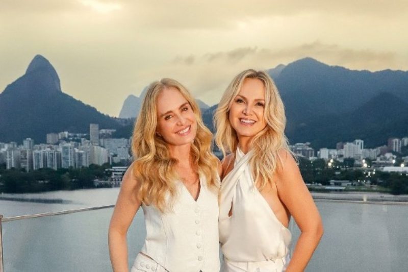 na foto aparecem eliana e angélica sorrindo e ao fundo a lagoa Rodrigo de Freitas ao fundo