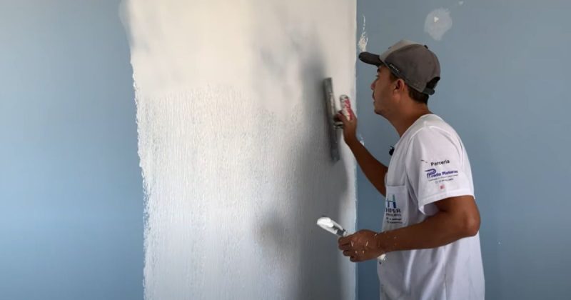 Pintor emassando a parede