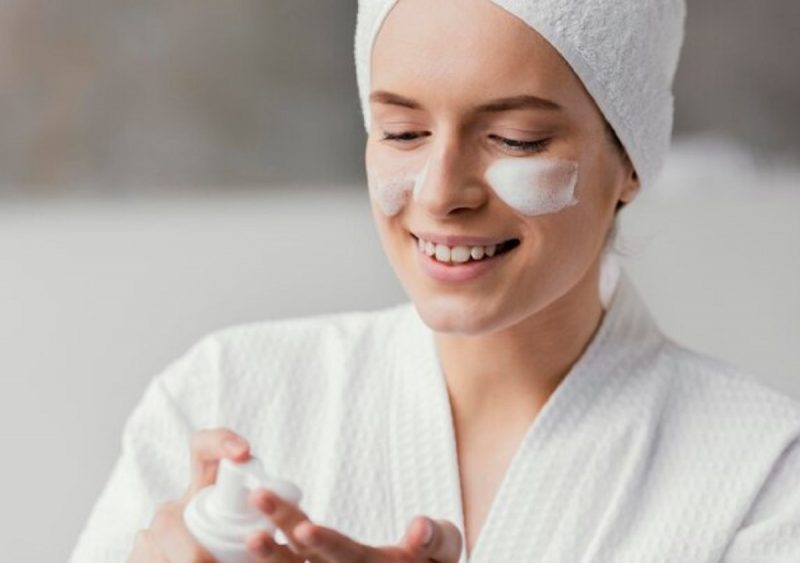 mulher aparece aplicando creme facial na pele rachada