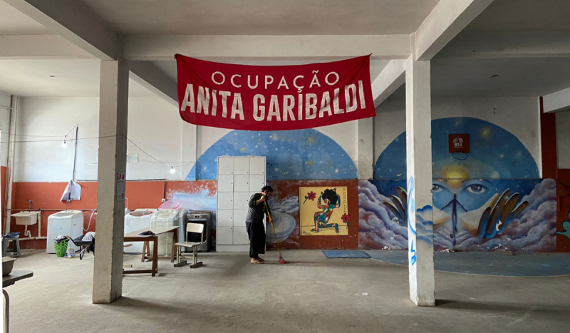 Ocupação em SC - Bandeira vermelha no teto com a frase Ocupação Anita Garibaldi