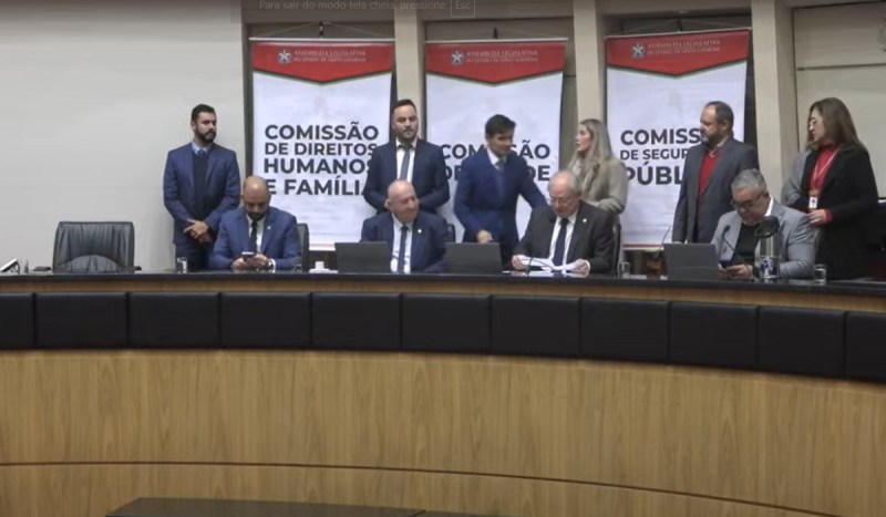 Homens de terno sentados juntos na bancada da Assembleia Legislativa em Santa Catarina