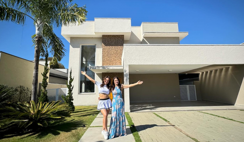 Bia do Brás e a mãe comemoram compra de casa de luxo - foto mostra duas mulheres brancas em pé com braços levantados comemorando compra de casa nova 