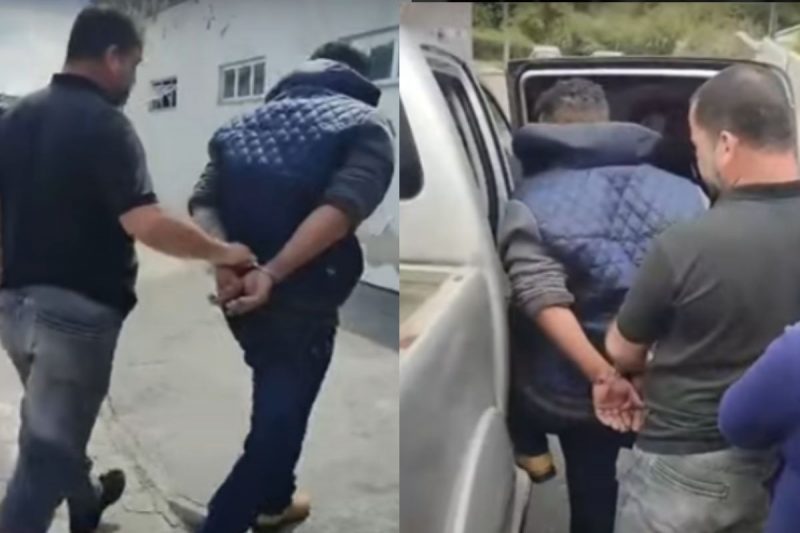 Foragido capturado pela polícia sendo conduzido até a viatura