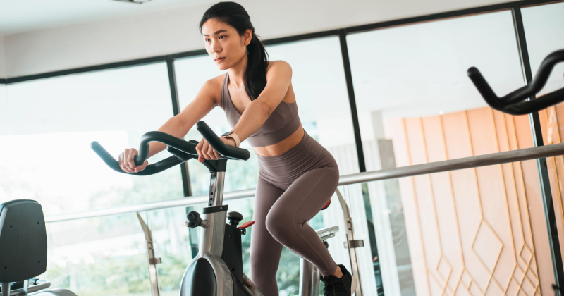 Mulher em cima de bicicleta ergométrica 