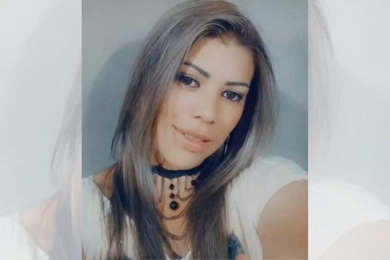 Andreia Varella, de 35 anos com uma blusa branca e um colar preto no pescoço, cabelo solto na altura do ombro, com meio sorriso e o rosto levemente inclinado, ela foi encontrada enforcada