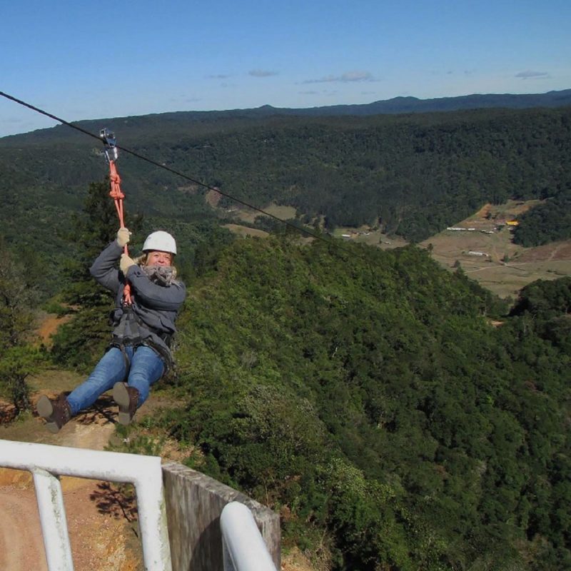 Mulher descendo maior tirolesa da América