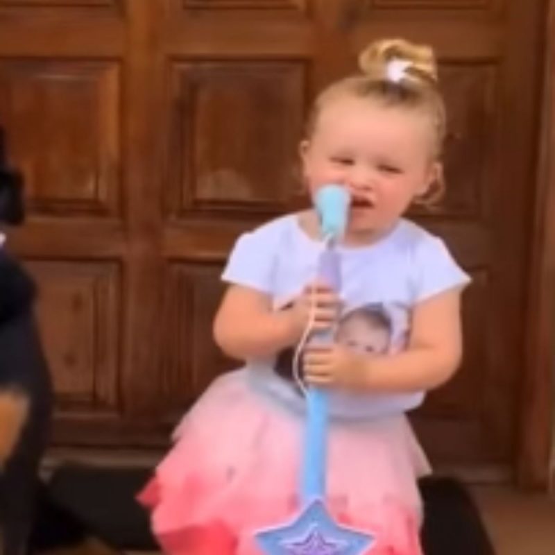 Menina cantando com cachorro