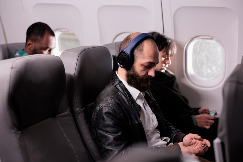 Pessoas no avião com fone de ouvido 