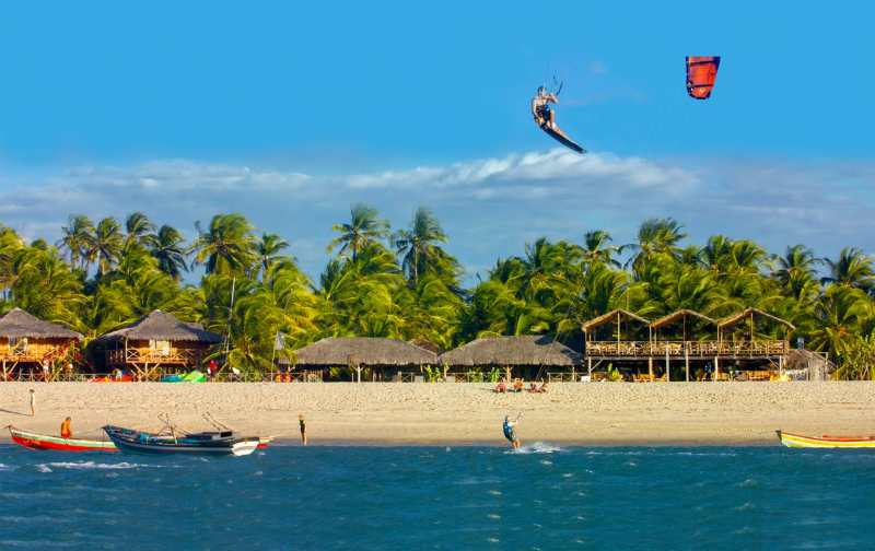 Pessoa praticando Kitesurf em praia paradisíaca 