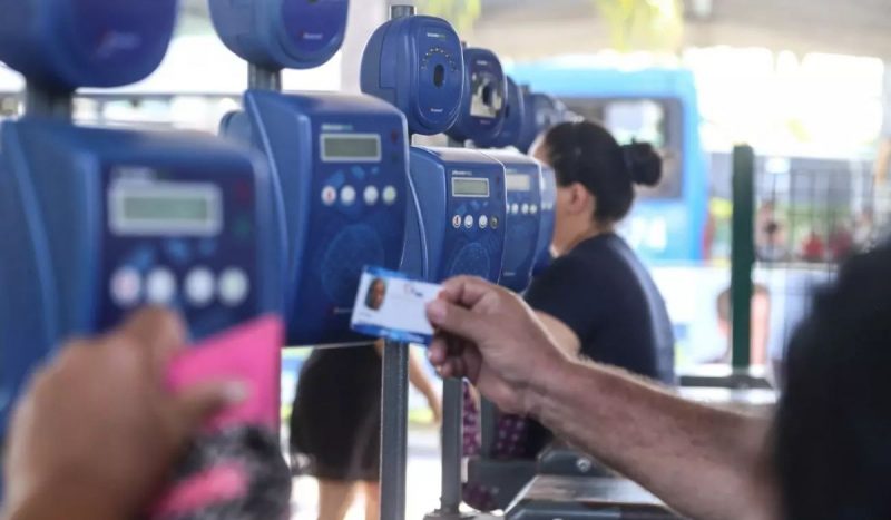 Renovação do Cartão Estudante em Florianópolis já está disponível para 2025. Na imagem, para ilustrar, pessoas passam na catraca de pagamento de um terminal de ônibus