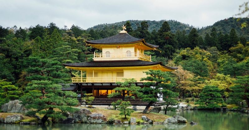 Parte externa de casa japonesa ao lado de lago