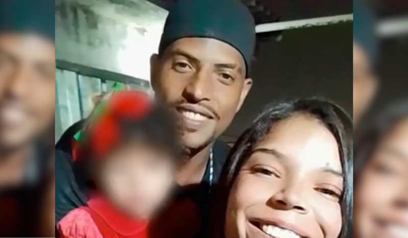 Paula Daniele e Paulo Henrique sorrindo com filha no colo. Rosto da criança está borrado