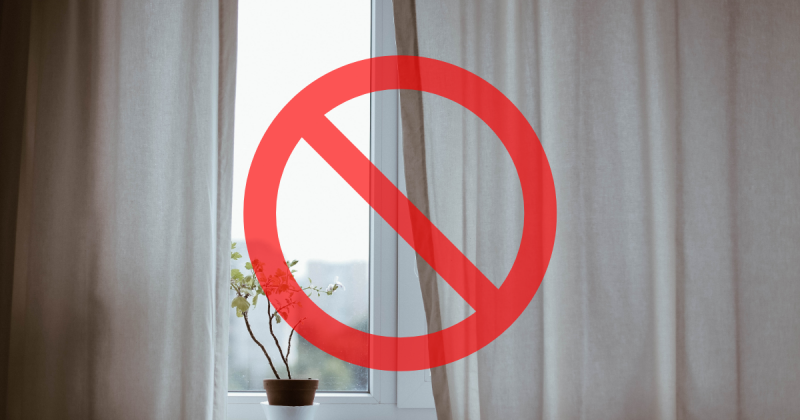 Imagem de uma janela com cortina e um proibido na frente, para fazer alusão a matéria com tema dê adeus às cortinas: nova tendência de 2025 é muito mais elegante e surpreendente