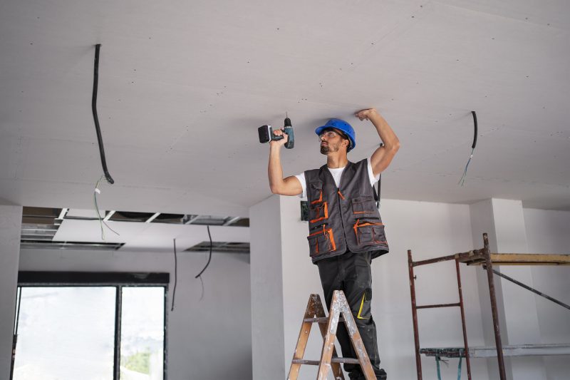 Homem instalando um teto de gesso 