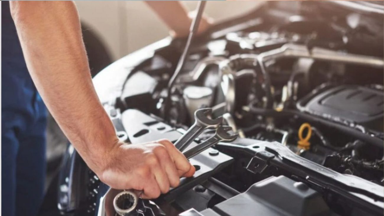 na foto aparece um mecânico com uma ferramenta na mão tentando entender como aquecer o motor de um carro na foto aparece um mecânico com uma ferramenta na mão tentando entender como aquecer o motor de um carro