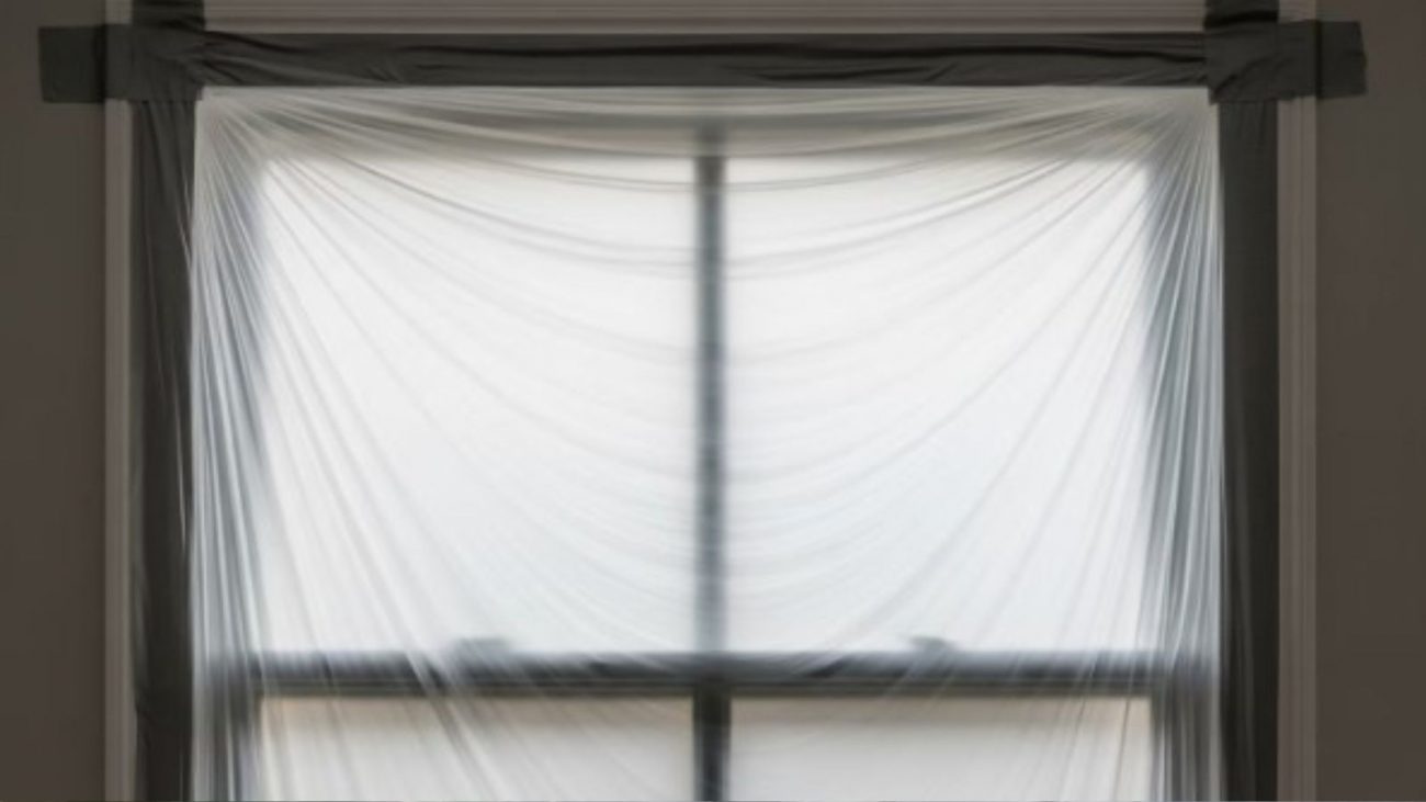 na foto aparece uma janela para com plástico, o truque genial para manter sua casa quentinha no inverno