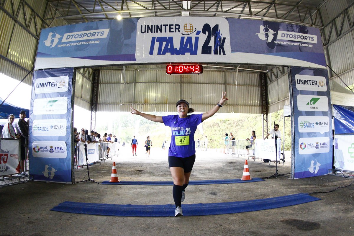 Corredora atravessa linha de chegada da Meia Maratona de Aniversário de Itajaí