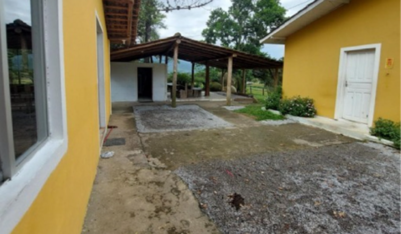 Quintal sujo em centro de reabilitação de Paulo Lopes Quintal com casas amarelas em centro de reabilitação de Paulo Lopes