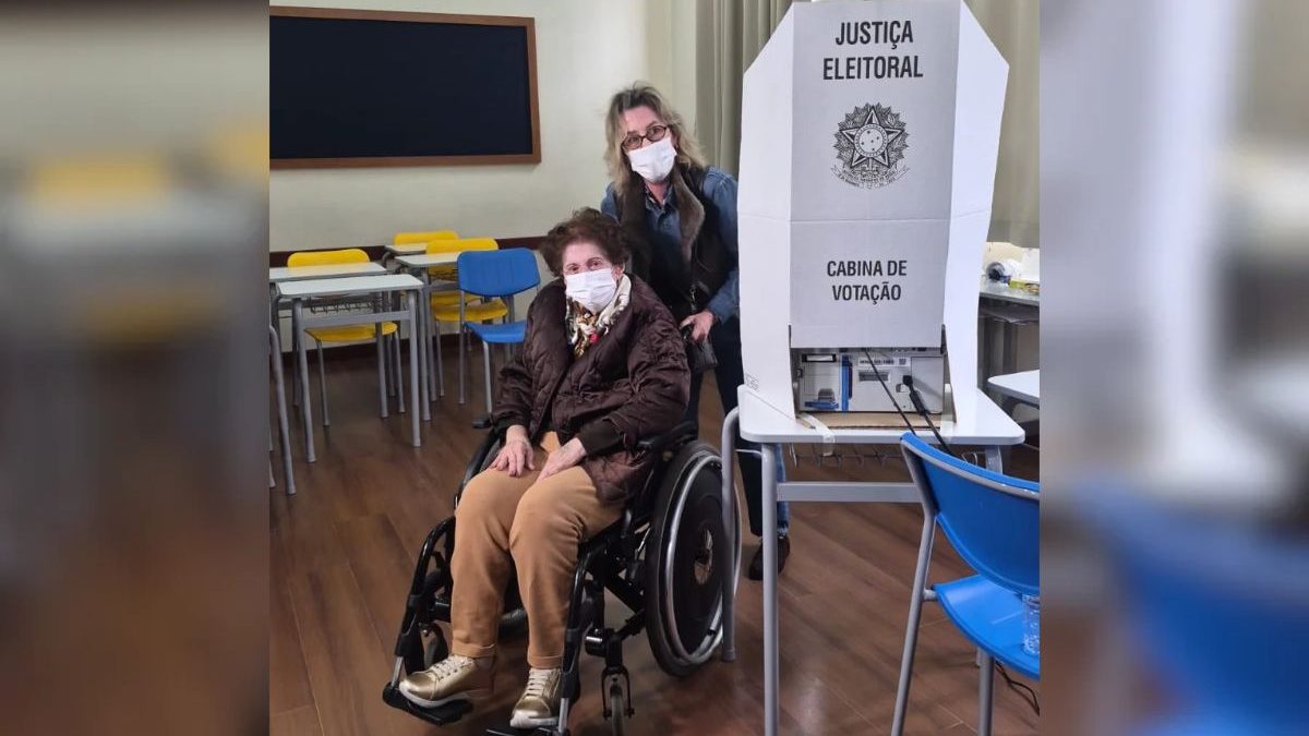 VÍDEO: Aos 103 anos, idosa de máscara e cadeira de rodas vai votar no primeiro turno das Eleições 2026 em SC